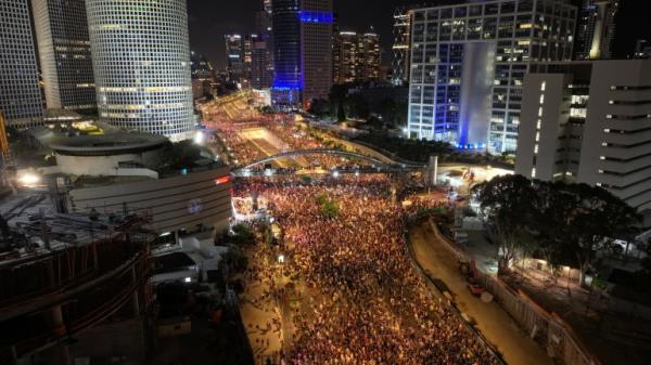 People attend a protest against the government in Tel Aviv